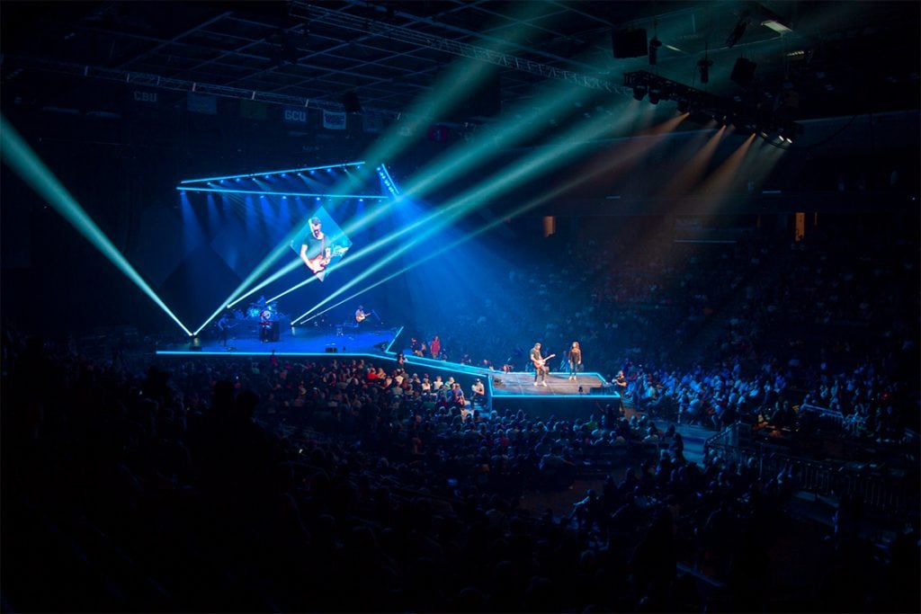 A concert with a blue light show at the GCU Arena