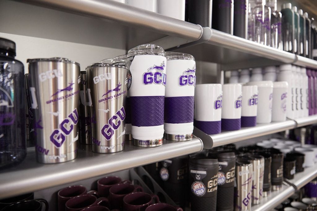 Shelf of different GCU cups and mugs at the GCU Lope Shop