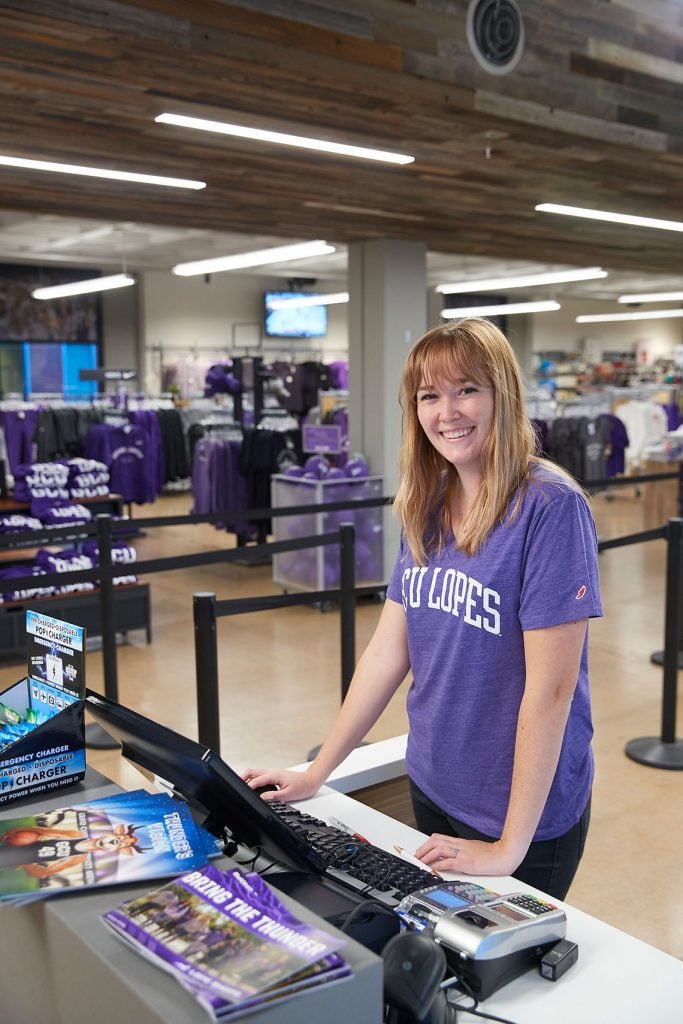 Female student worker at the cash register at the GCU Lope Shop