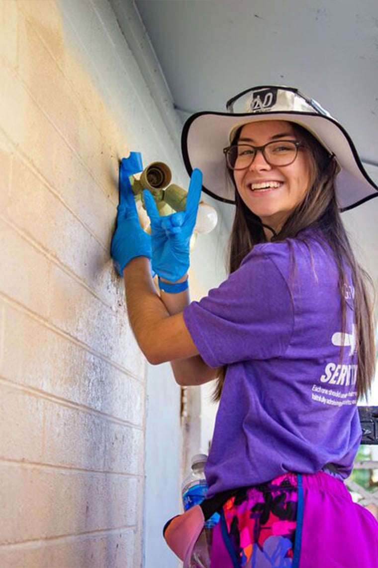 GCU Female student smiling will volunteering for Habitat for Humanity