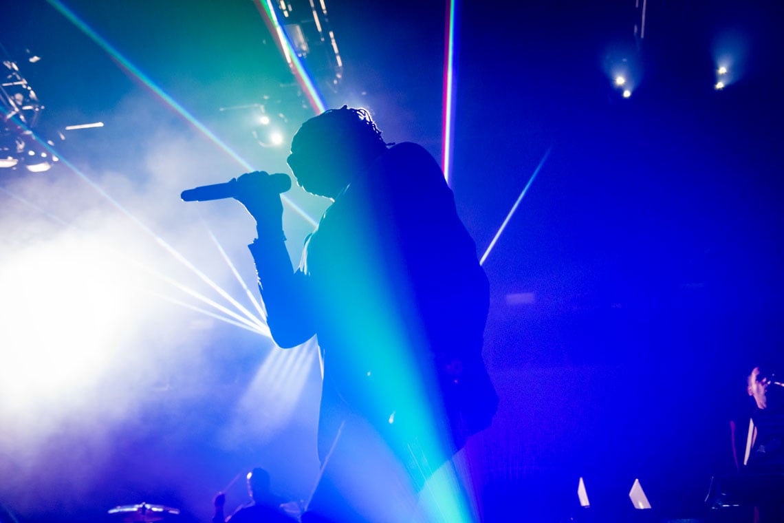 Singer under fog and light at the GCU Arena